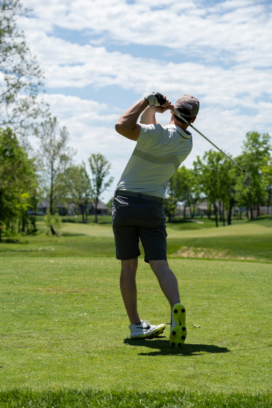 man-in-white-t-shirt-and-black-shorts-holding-golf-club-kaz6uu54zje